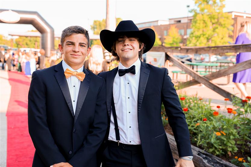 Two young men stand on the red carpet at the 2022 WILLCO Awards